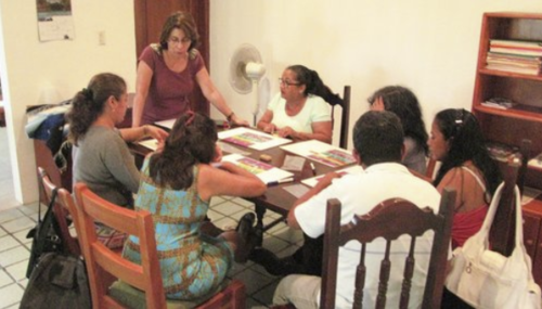 Figure 4. Miriam Chacón (standing), the Galapagos leader of the program, facilitates a Learning Circle with Santa Cruz teachers. Photo: ESG Program archive