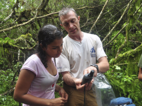 Figure 4. Dr. Steve Blake teaches a student how to record the location where a scat sample was found, for future analysis. Photo: EPI Archive